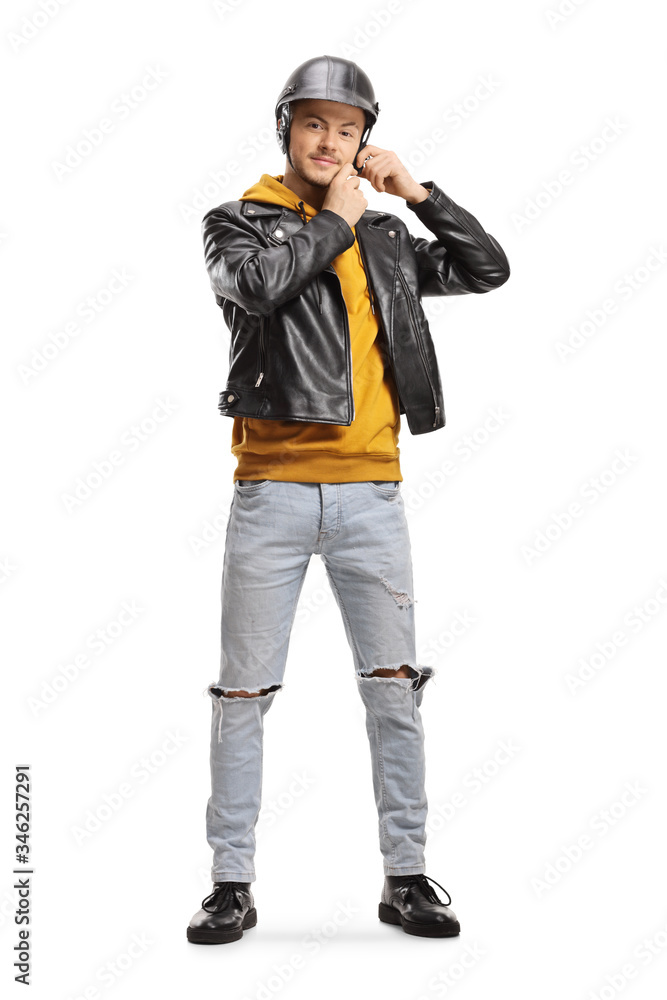 Young man in a leather jacket putting on a helmet Young man in a leather jacket putting on a helmet