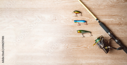 Fishing tackle-fishing spinning, lures on a wooden background.