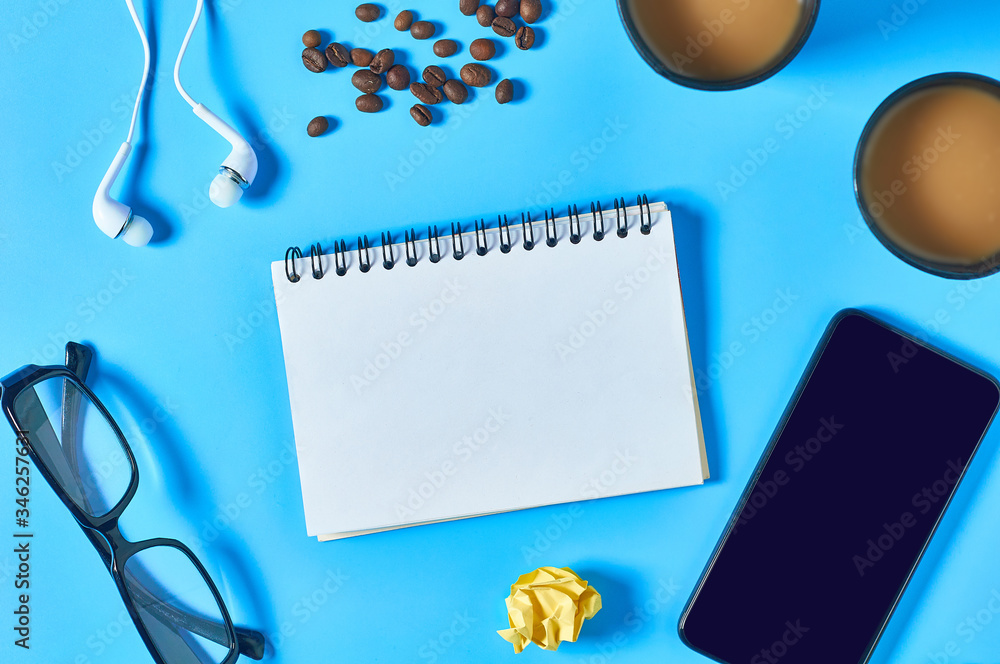 Office workplace with different accessories, tools and gadgets on blue table. Business concept. Top view Office workplace with different accessories, tools and gadgets on blue table. Business concept. Top view