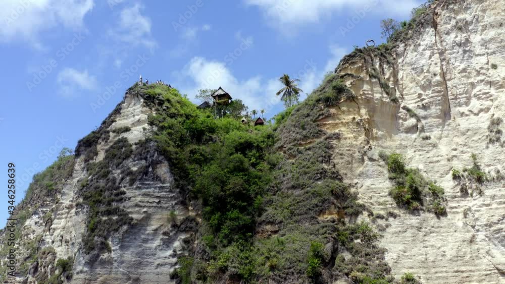 Lookout post above rock wall at Diamond Beach in Nusa Penida island Indonesia, Aerial orbit left reveal shot Lookout post above rock wall at Diamond Beach in Nusa Penida island Indonesia, Aerial orbit left reveal shot