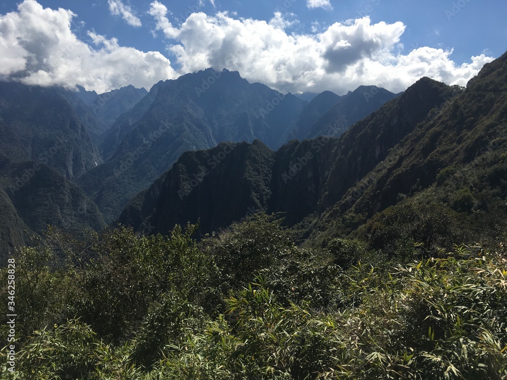 Naklejka premium Beautiful panoramic view of famous mountains machu picchu peru, south america. Inca city, peruvian civilization. Green Landscape, panorama of andes