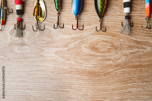 Fishing lures on a wooden background close up