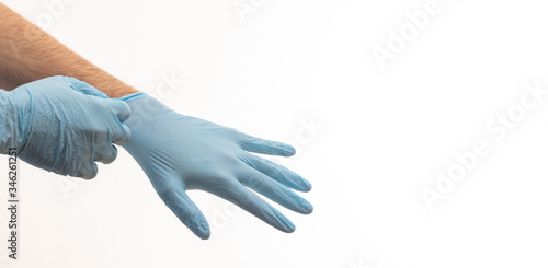 Fototapeta Naklejka Na Ścianę i Meble -  Doctor putting on medical gloves isolated on white background.