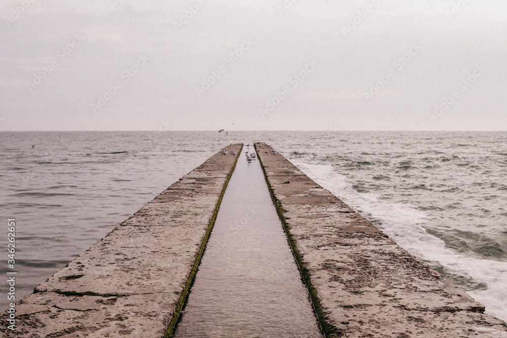 Concrete pier on the background of the sea Concrete pier on the background of the sea
