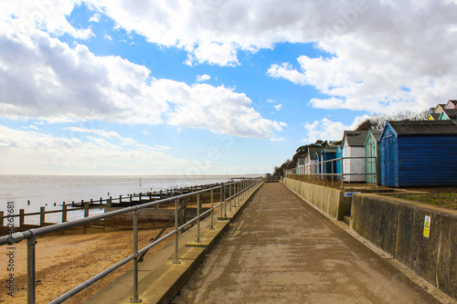 walkway with beach huts next to the beach © SDG Productions