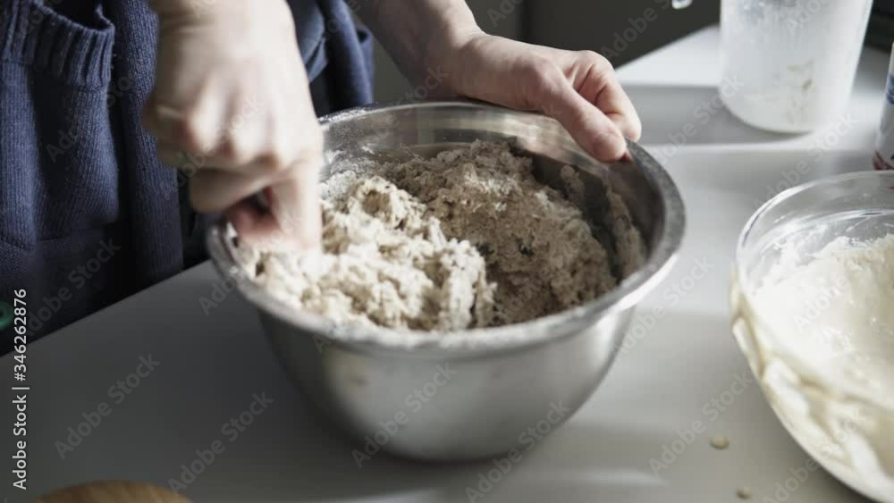 Detail of mixing bread dough with a wooden spoon
Detail of mixing bread dough with a wooden spoon