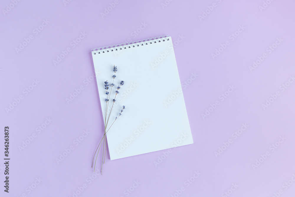 Notebook with blank page and lavander on a violet background. Notebook with blank page and lavander on a violet background.