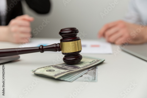 Legal alimony concept. Closeup view of wooden gavel and money photo