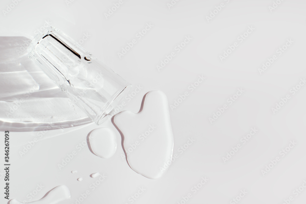 Horizontal close up of dropped glass of water with spilled water on white surface with shadows on sunlight of sunset or sunrise. Drinking fresh water for health and beauty or carelessness Horizontal close up of dropped glass of water with spilled water on white surface with shadows on sunlight of sunset or sunrise. Drinking fresh water for health and beauty or carelessness