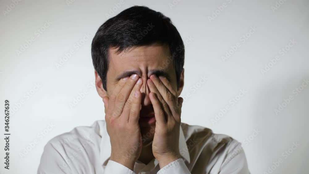 Tired man rubs his eyes Tired man rubs his eyes