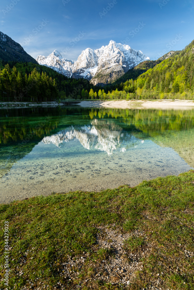 Jasna lake at Kranjska Gora in Slovenia, Europe on a beautiful spring morning. Jasna lake at Kranjska Gora in Slovenia, Europe on a beautiful spring morning.