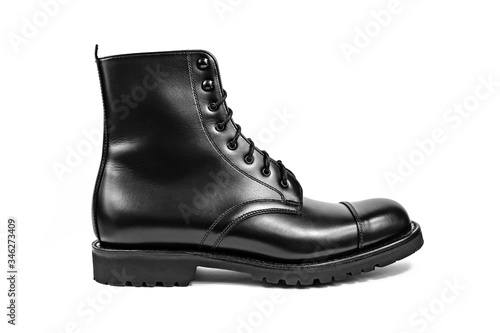 Classic black shiny leather boot shot sideways on in a white studio.