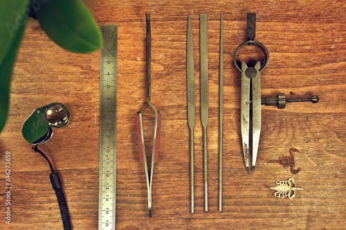 classic jewel workshop tools over a table wood photo