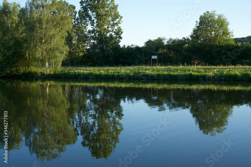 Reflections of trees in the water of the river.