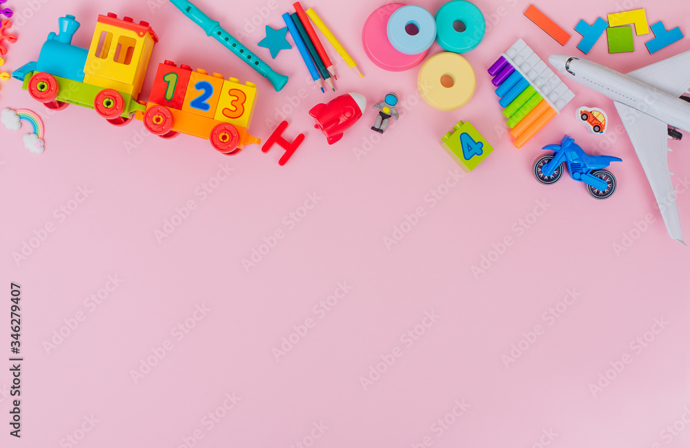 Frame of kids plastic toys on pink background with blank space Frame of kids plastic toys on pink background with blank space