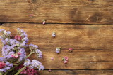 purple flowers on wooden background
