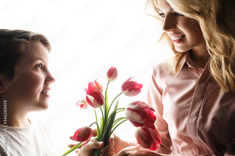 Woman and child with a bouquet of tulips Woman and child with a bouquet of tulips