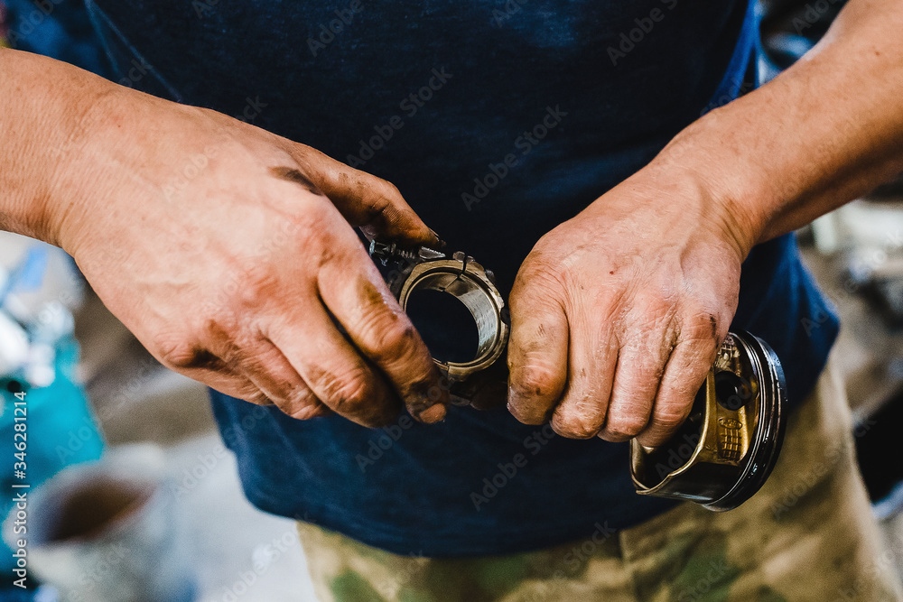 hands of a car mechanic in work with car parts hands of a car mechanic in work with car parts
