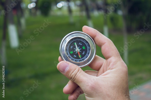 the guy holds a compass