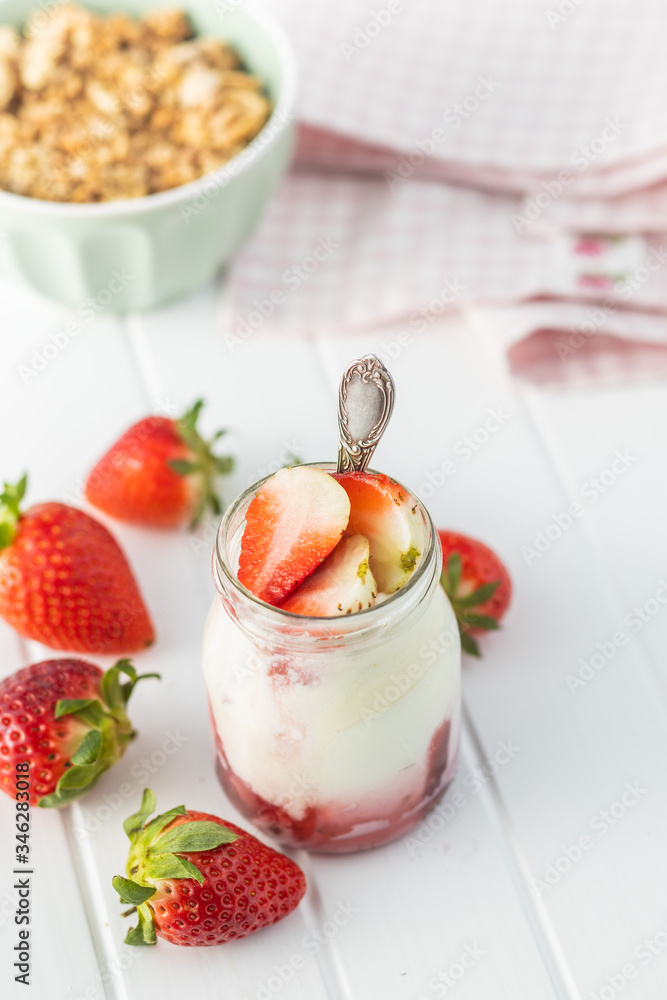 White fruity yogurt in jar and strawberries. White fruity yogurt in jar and strawberries.