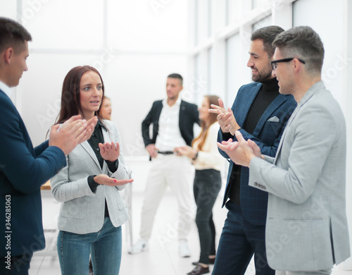 group of business people applauding standing in the office