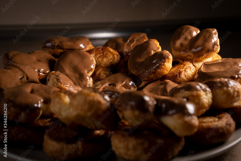 Chocolate palmier biscuits on a plate. Heart-shaped puff pastry, pig's ear, palm leaves cookies, elephant ears, french hearts, shoe-soles. Chocolate palmier biscuits on a plate. Heart-shaped puff pastry, pig's ear, palm leaves cookies, elephant ears, french hearts, shoe-soles.