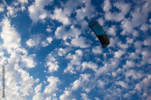 kitesurfer rides a kite-surf on waves of the sea
