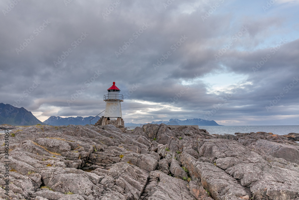 Lighthouse in Norwegian fjords, Norway. Sea mountain landscape view.