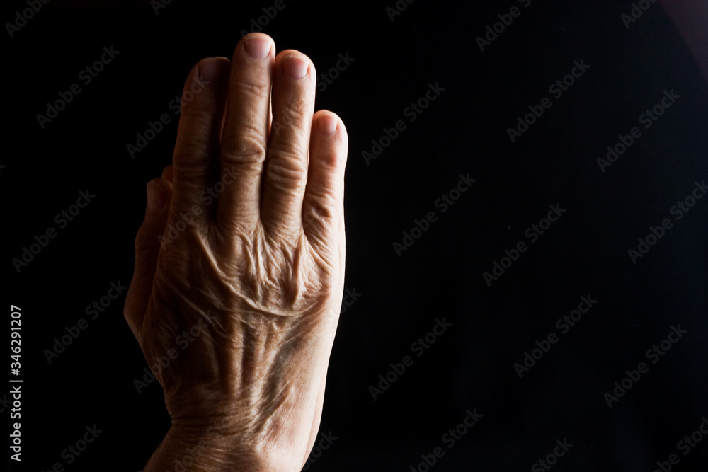 Praying old grandmother in silence close-up. Old wrinkled hands in prayer. Wrinkles on old mother hands closeup. Aged mother asks God for the protection of children. Parents value social photo. Praying old grandmother in silence close-up. Old wrinkled hands in prayer. Wrinkles on old mother hands closeup. Aged mother asks God for the protection of children. Parents value social photo.