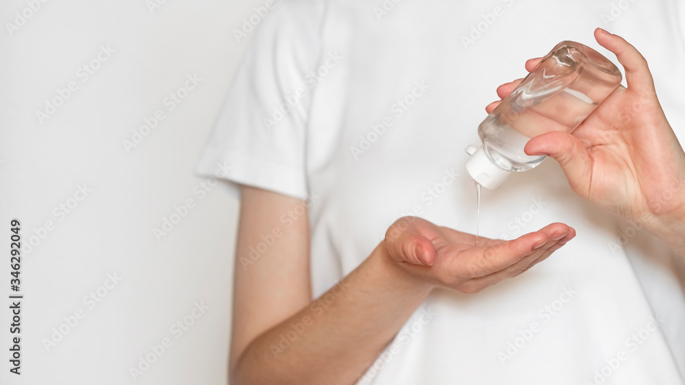 Closeup of woman using antibacterial sanitizer gel in bottle on hands. Closeup of woman using antibacterial sanitizer gel in bottle on hands.