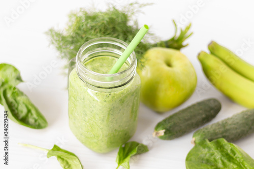 Mixed green smoothie with ingredients