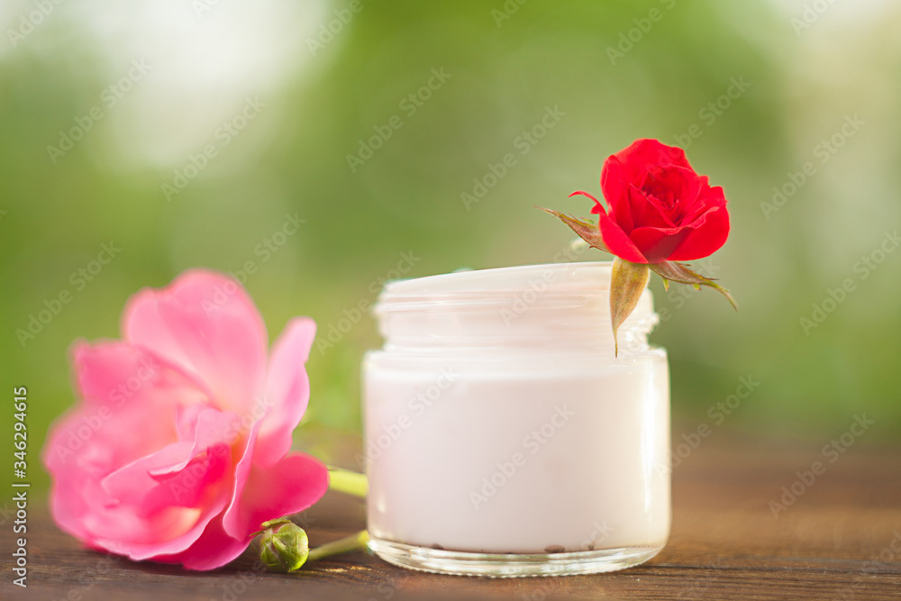 Essence of rose on table in beautiful glass bottle Essence of rose on table in beautiful glass bottle