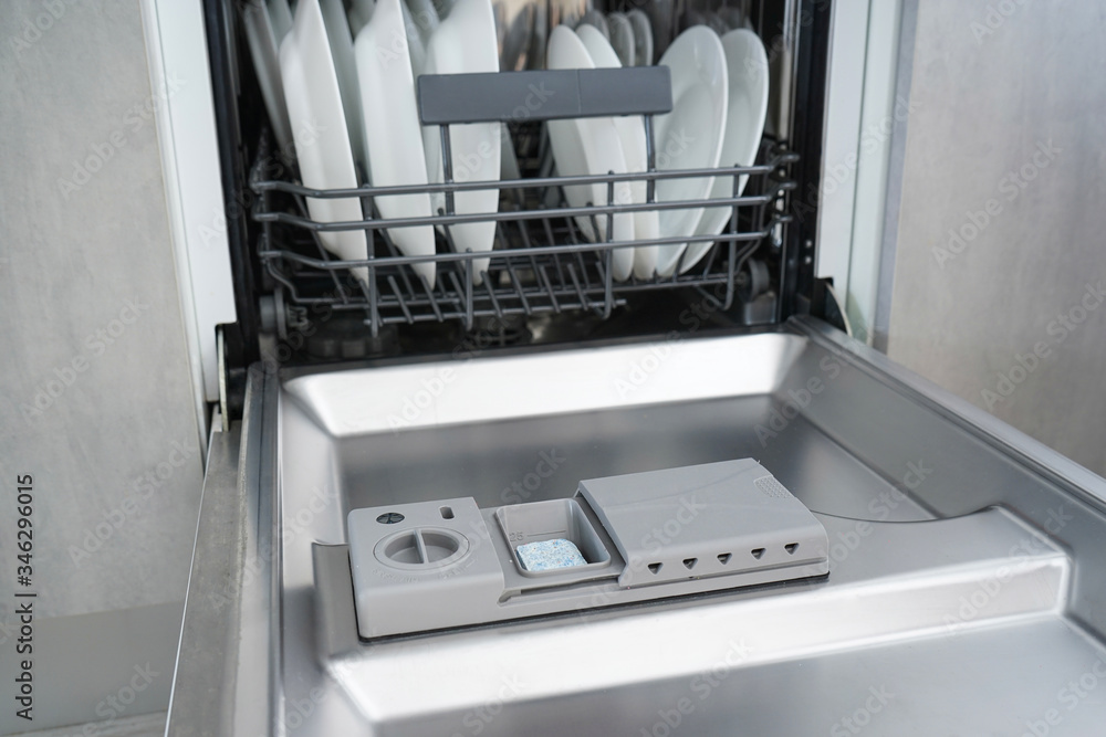 Open dishwasher with clean dishes. Close-up. Open dishwasher with clean dishes. Close-up.