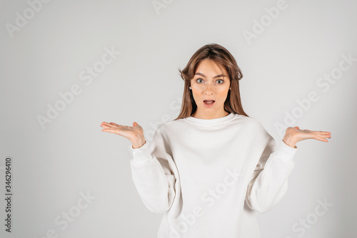Woman excited looking to the camera. Surprised happy young woman looking forward in excitement