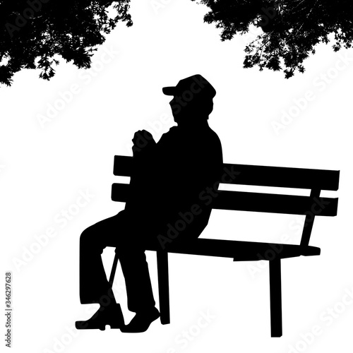 Old man silhouette sitting on a park bench