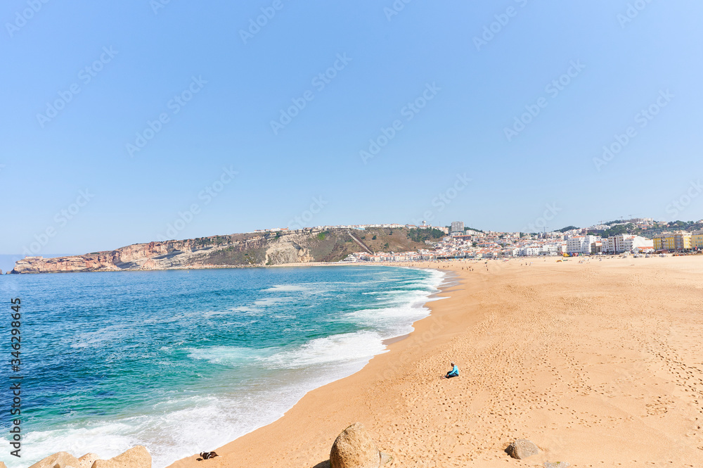 Summer morning at beach of Nazaré in Portugal