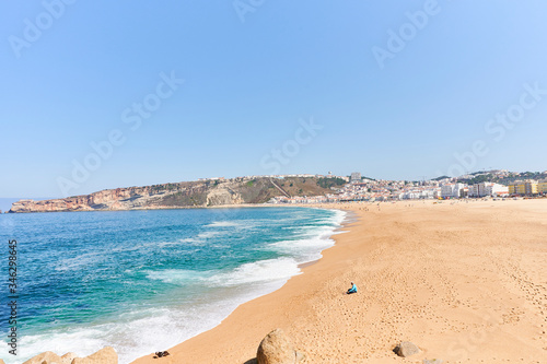 Summer morning at beach of Nazaré in Portugal