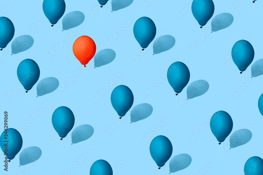 blue balloons symbolizing society. Red balloon symbol of the leader, a person who stands out from the crowd. the concept of uniqueness