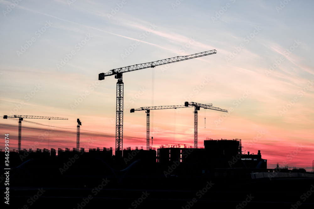 Construction crane on the background of the sunset Construction crane on the background of the sunset