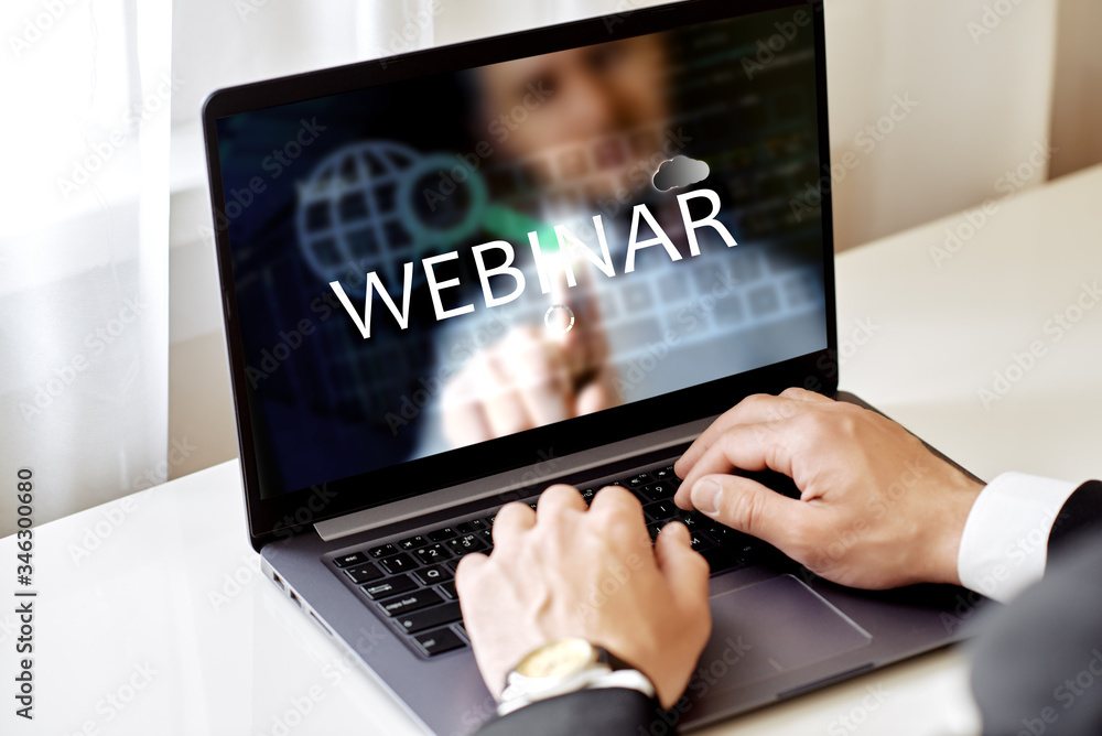 Webinar concept, training on the Internet. man works with a laptop with the inscription Webinar Webinar concept, training on the Internet. man works with a laptop with the inscription Webinar