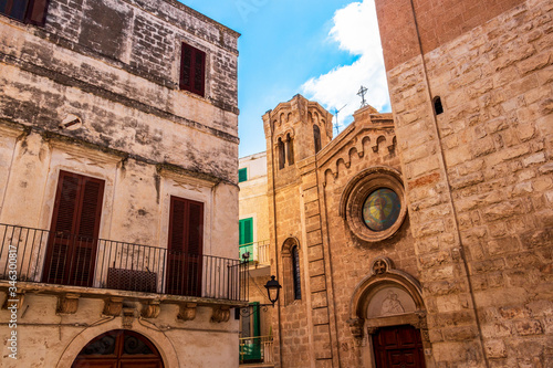 Church of Santa Maria Assunta between other old buildings, old architecture in Fasano, Province of Brindisi, Apulia, Italy, high section street view