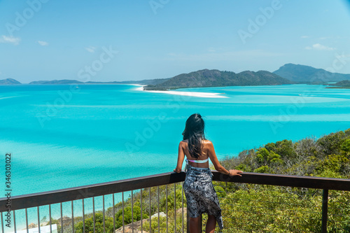Woman Tourist at beach ocean view,. Whitehaven Whitsundays. Turquoise ocean, white sand. Dramatic DRONE view from above. Travel, holiday, vacation, paradise. Shot in Hill Inlet, Queenstown, Australia.