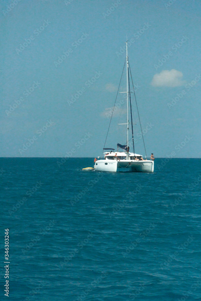Catamaran sailing in ocean. Whitehaven beach, Whitsundays. Turquoise ocean. Travel, holiday, vacation, paradise. Shot in Hill Inlet, Queenstown, Australia.