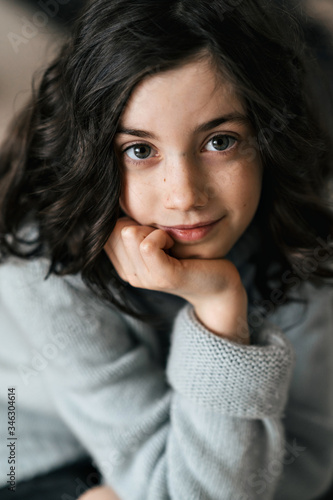 Close-up portrait of a charming European girl of 8 years old. She has beautiful wavy, loose hair.