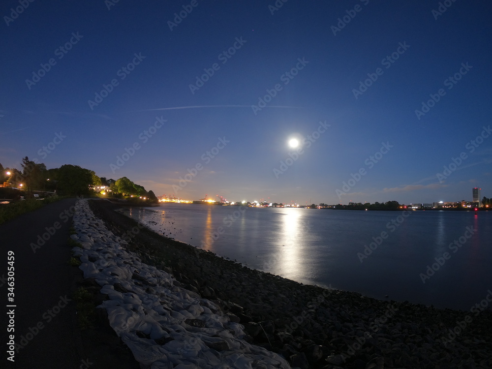 Full moon on the elbe river in the city of hamburg germany