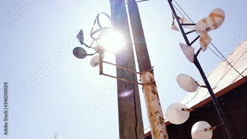 An Old Wind Spinner at a Power Line Post. Zoom In. photo