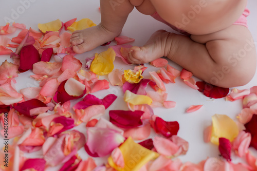 a child's foot in rose petals