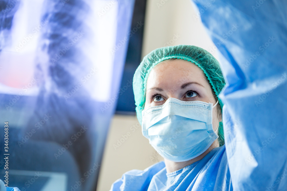 Doctor in her office with lung x-ray. Doctor in her office with lung x-ray.