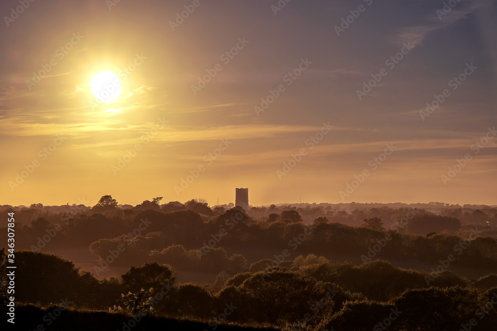 Sunset over the countryside in Suffolk, England with Lavenham´s church tower in the background