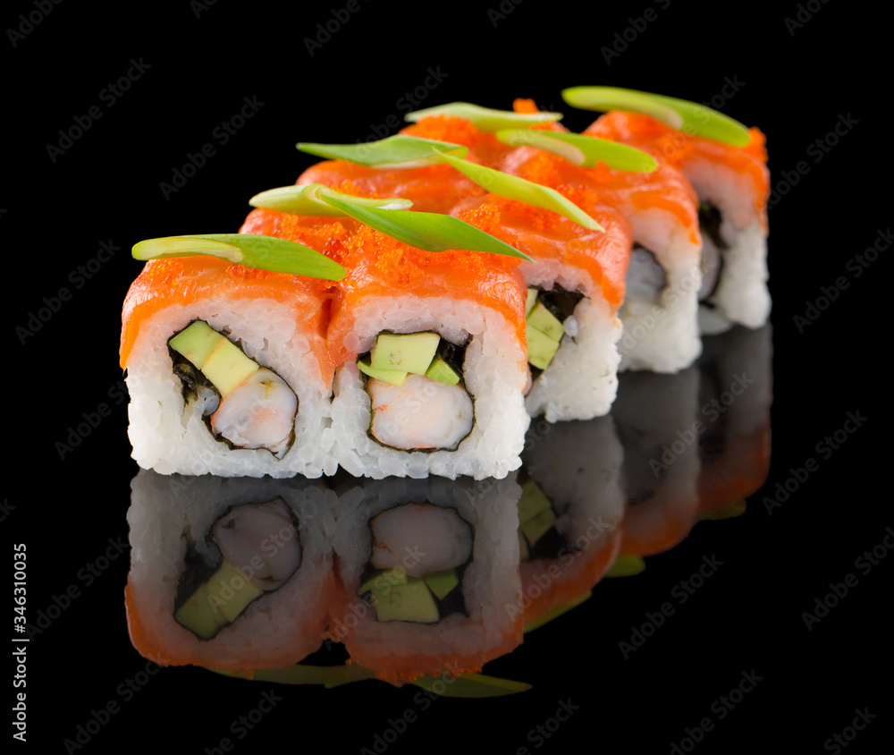 Sushi roll with salmon, shrimp, avocado, tobiko and chive isolated on black background with reflection Sushi roll with salmon, shrimp, avocado, tobiko and chive isolated on black background with reflection